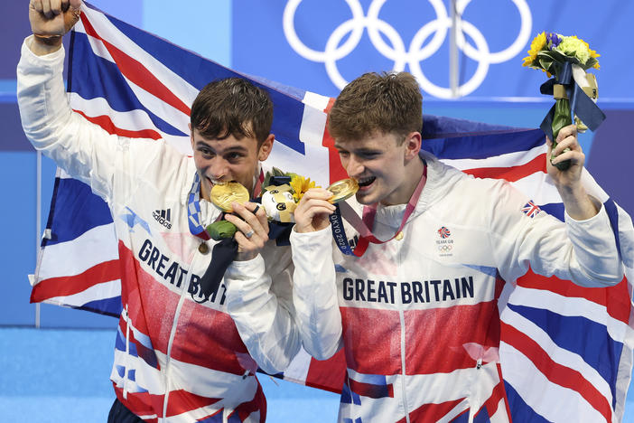Tom Daley, left, and Matty Lee celebrate their win in the men's synchronized 10m platform final on day three of the Tokyo 2020 Olympic Games.