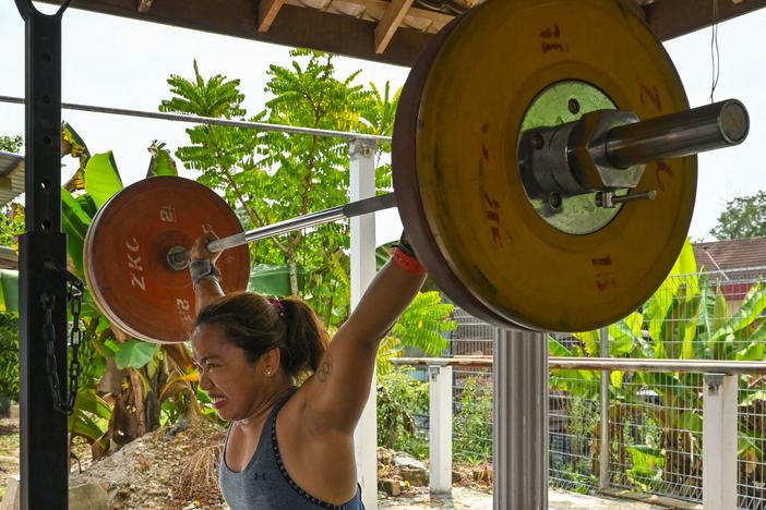 Hidilyn Diaz of the Philippines lifts weights during a training session on May 21 in the Malaysian city of Malacca. She had been stuck in Malaysia because of the pandemic.
