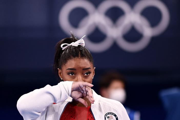 Simone Biles looks on during the women's gymnastics team final during the Tokyo Olympics on Tuesday. After competing on the vault, Biles withdrew from team competition.