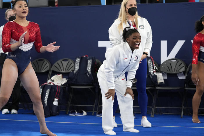 Simone Biles (center) cheers the performance of teammate Grace McCallum after she withdrew from the artistic gymnastics women's final at the Summer Olympics on Tuesday in Tokyo.