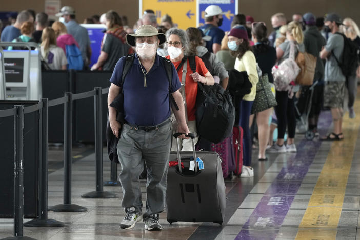 Travelers head to a security checkpoint at Denver International Airport on July 2. The economy likely surged in the April-June quarter as vaccine rollouts sparked a surge in pent-up activity. A slowdown is now seen as inevitable, although the pace of growth should remain strong.