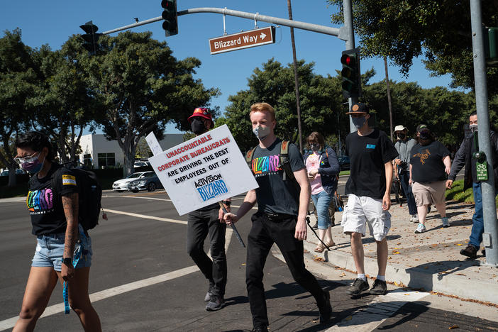 Employees walk across Blizzard Way during a walkout at Activision Blizzard offices in Irvine, Calif., on Wednesday.