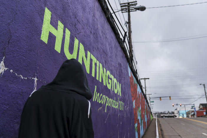 A pedestrian walks past a mural in Huntington, W.Va., on March 18. Huntington was once ground zero for the U.S. opioid epidemic.