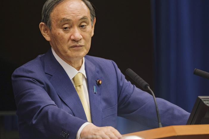 Japanese Prime Minister Yoshihide Suga will extend a state of emergency to four more prefectures due to rising coronavirus infections. Here, Suga addresses a news conference on July 8.