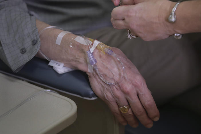 As part of a clinical study, a patient with Alzheimer's disease receives an infusion of aducanumab at a Providence, R.I., hospital in 2019. Aducanumab is being marketed as Aduhelm.