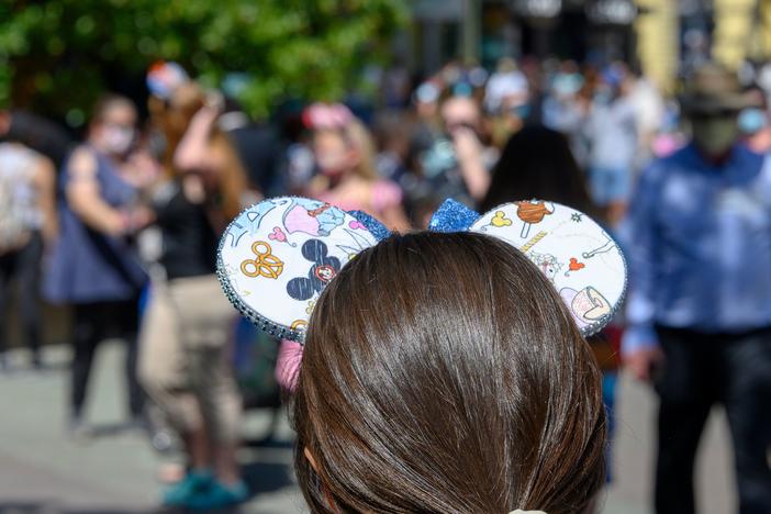 People visit Downtown Disney in Anaheim, California on July 9, 2020, the first day the outdoor shopping and dining complex was open to the public since closing in March amid the onset of the COVID-19 pandemic.