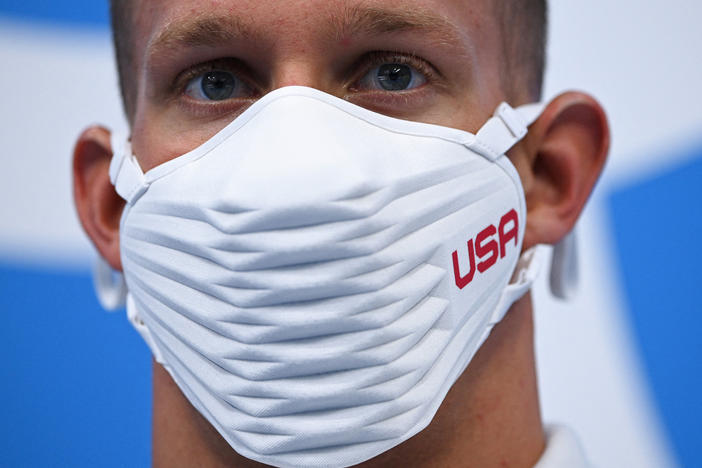 Team USA's Caeleb Dressel wears a USA-branded face covering while waiting to receive his gold medal after the final of the men's 4x100 meter freestyle relay swimming event during the Tokyo Olympics at the Tokyo Aquatics Centre on Monday.