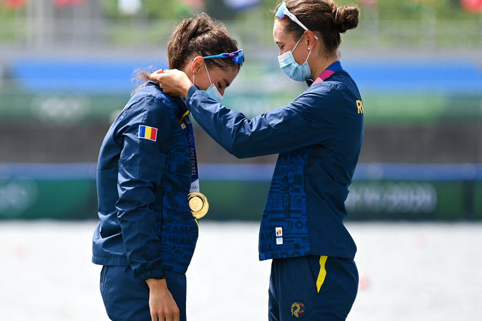 Gold medalists Ancuta Bodnar and Simona Radis of Romania celebrate on the podium following the women's double sculls final at the Tokyo Olympics on Wednesday.