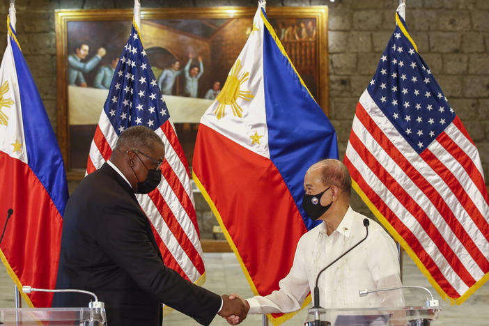 U.S. Defense Secretary Lloyd Austin, left, and Philippines Defense Secretary Delfin Lorenzana shake hands after a bilateral meeting at Camp Aguinaldo military camp in Quezon City, Metro Manila, Philippines Friday, July 30. Austin is visiting Manila to hold talks with Philippine officials to boost defense ties and possibly discuss the The Visiting Forces Agreement between the US and Philippines.