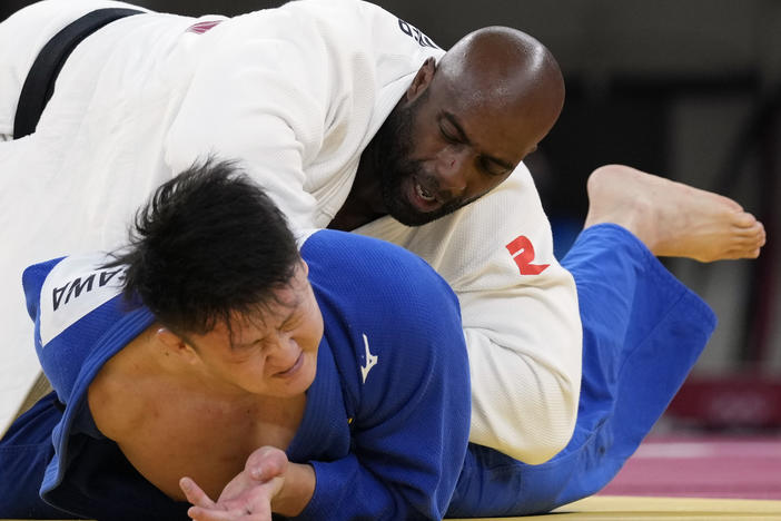 Riner (top) and Japan's Hisayoshi Harasawa compete Friday during the men's over 100-kilogram bronze medal judo match.