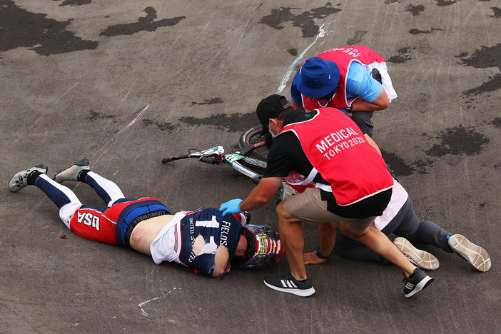 U.S. BMX racer Connor Fields receives medical treatment after a crash during a men's BMX semifinal heat at the Ariake Urban Sports Park in Tokyo.
