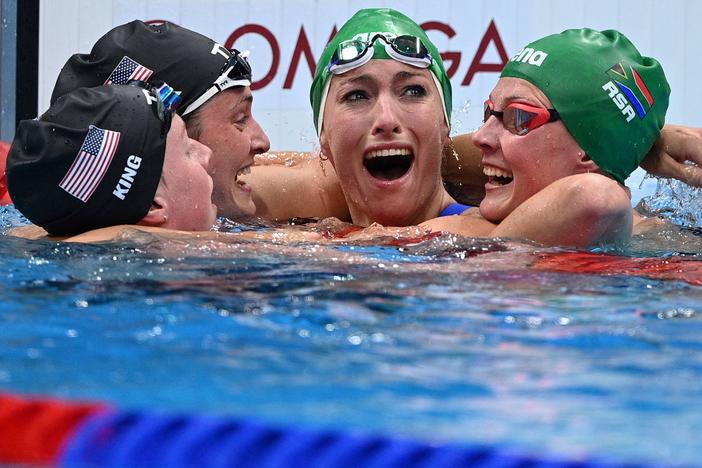 South Africa's Tatjana Schoenmaker, second from right, cheers with teammate Kaylene Corbett, right, and medalists Annie Lazor and Lilly King of Team USA after winning the final of the women's 200m breaststroke swimming event at the Tokyo Aquatics Centre on Friday.
