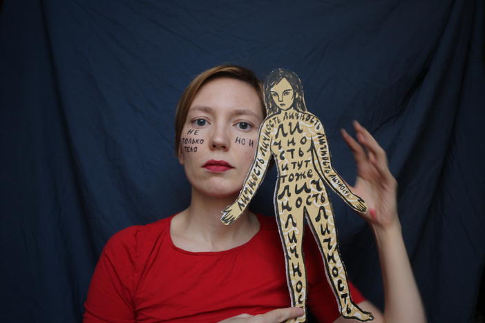 A self-portrait of Darya Apakhonchich, with the writing on her face and a figure of a woman saying: "Not only a body but a person, person, person, person, person." She made the photo in support of Russian artist and LGBTQ activist Yulia Tsvetkova, who faces criminal charges for spreading pornography through her art.