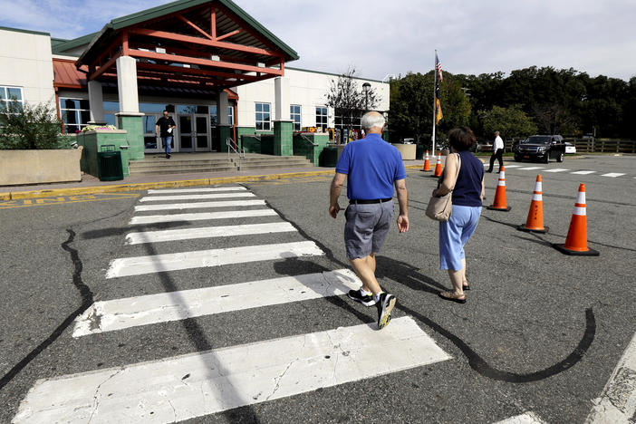 People head into the service building at the Cheesequake Rest Area in South Amboy, N.J.