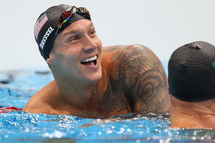 U.S. star Caeleb Dressel reacts after winning the gold medal and breaking the Olympic record in the men's 50 meter freestyle final at the Tokyo Olympics.