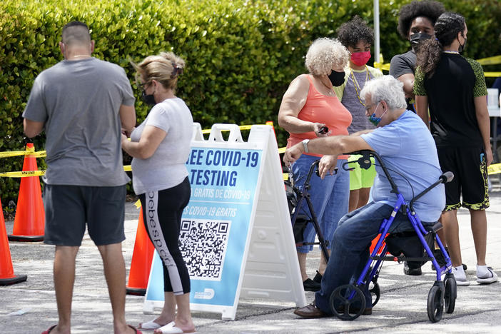People wait in line at a Miami-Dade County COVID-19 testing site, Monday, July 26, 2021, in Hialeah, Fla. Florida accounted for a fifth of the nation's new infections last week, more than any other state, according to the CDC.