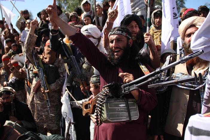 Afghan Taliban fighters and villagers attend a gathering in Laghman province, Alingar district, in March 2020 as they celebrate the peace deal signed between the U.S. and the Taliban.