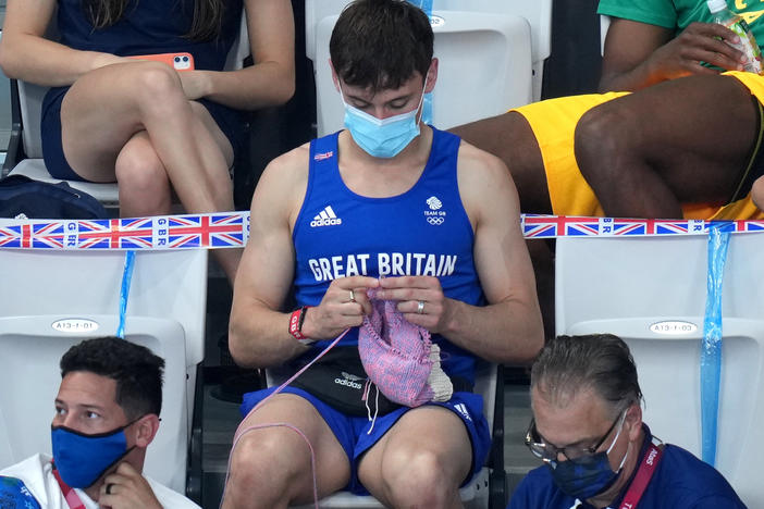 Great Britain's Tom Daley knits in the stands Sunday during the women's 3-meter springboard final at the Tokyo Aquatics Centre at the Olympic Games.