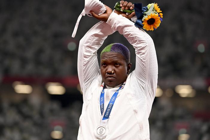 Team USA's Raven Saunders gestures on the podium with her silver medal after competing in the women's shot put event Sunday at the Tokyo Olympics.