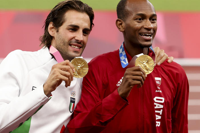 Gold medalists Gianmarco Tamberi of Italy and Mutaz Essa Barshim of Qatar shared the podium after the men's high jump at the Tokyo 2020 Olympic Games at Olympic Stadium.