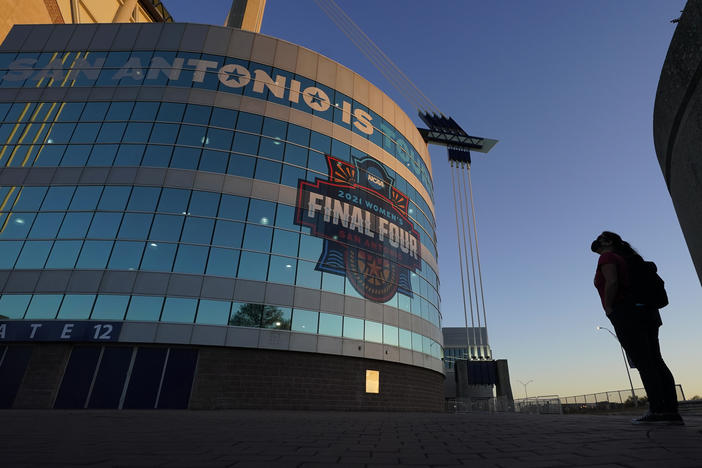 A visitor looks up at the logo for the Women's Final Four in San Antonio, as the city prepares to host the Women's NCAA College Basketball Championship, in this March 18, 2021, file photo.