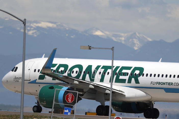 A Frontier Airlines aircraft at Denver International Airport in 2020. A 22-year-old passenger faces three misdemeanor charges after allegedly groping two flight attendants and assaulting a third.