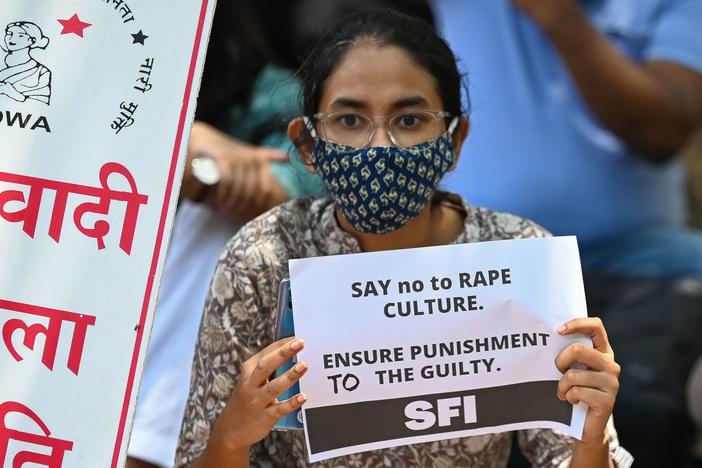 Activists hold placards during a protest Wednesday over the death of a 9-year-old girl in New Delhi. The girl's parents have accused a Hindu priest and three other men of raping and killing the child.