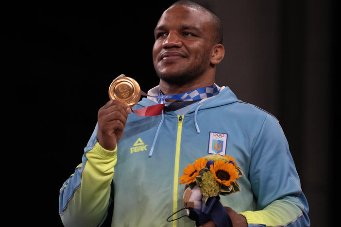 Gold medalist Zhan Beleniuk of Ukraine celebrates on the podium during the medal ceremony for men's 87-kilogram Greco-Roman wrestling.