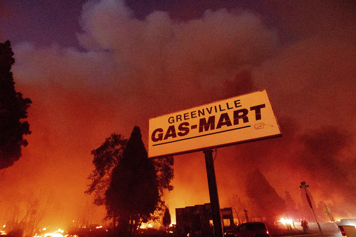 Flames consume buildings as the Dixie Fire tears through the Greenville community of Plumas County, Calif., on Aug. 4, 2021.