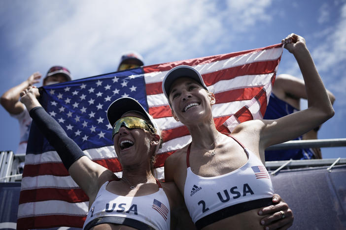 U.S. beach volleyball pair April Ross (left) and Alix Klineman celebrate winning a women's beach volleyball gold medal in a match against Australia at the Summer Olympics in Tokyo.