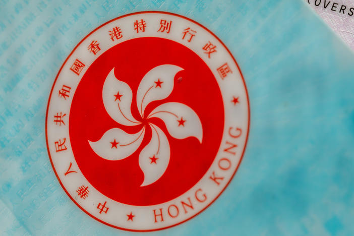 The Hong Kong Special Administrative Region (HKSAR) emblem on a page of the HKSAR passport arranged in Hong Kong, China, earlier this year. The Biden administration says it will allow Hong Kong residents to remain and work in the U.S. for at least 18 months without fear of deportation.