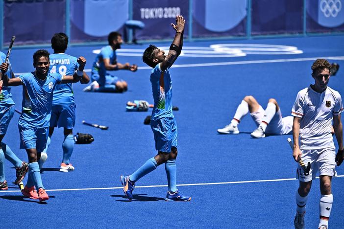 Indian field hockey players celebrate after winning the men's bronze medal match over Germany at the Tokyo Olympics.
