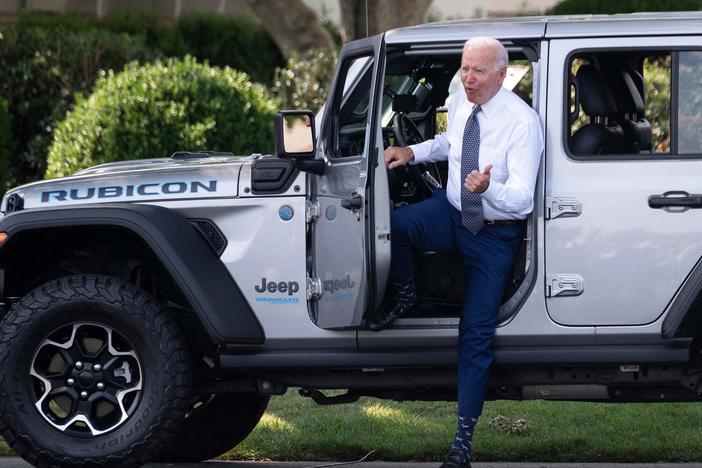 President Biden gets out of a Jeep Wrangler Rubicon 4xE after delivering remarks at the White House Thursday on electric vehicles and new fuel economy and emissions standards.