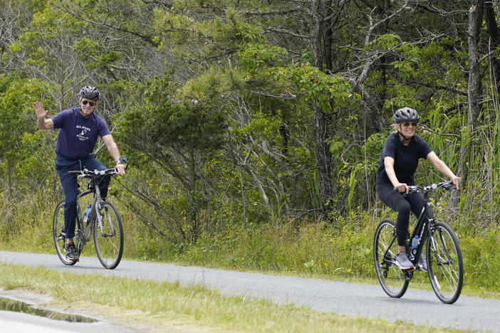 President Biden rides his bike in Rehoboth Beach, Del., earlier this year with first lady Jill Biden. The family has a beach house nearby.