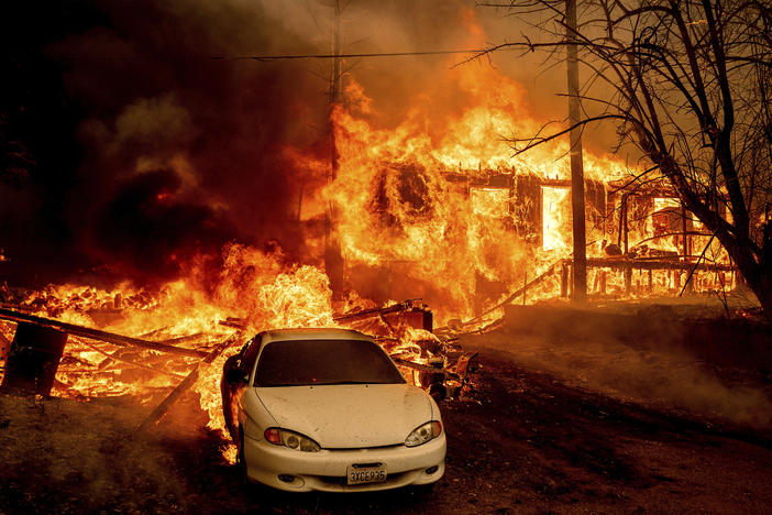 Flames from the Dixie Fire consume a home on Highway 89 south of Greenville, Calif., on Thursday.