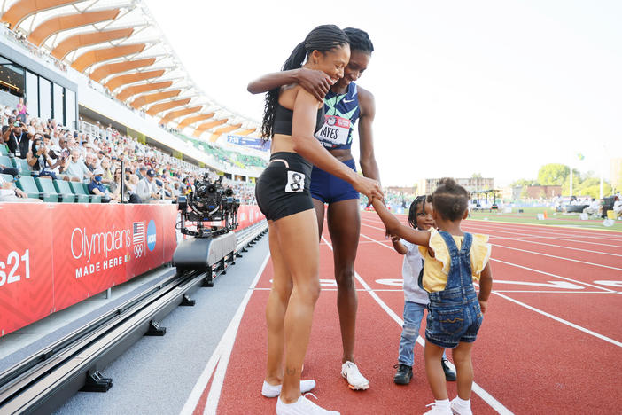 Allyson Felix and Quanera Hayes celebrate with their children after placing second and first respectively in the women's 400-meter final at U.S. Olympic Track & Field Team Trials in June in Eugene, Ore.