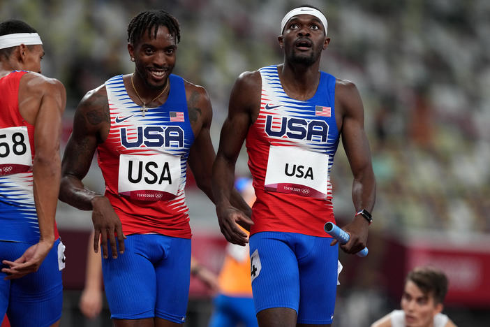 USA's Michael Cherry (left) and Rai Benjamin after winning gold in the men's 4 x 400 meter relay at the Olympic Stadium in Japan on Saturday.