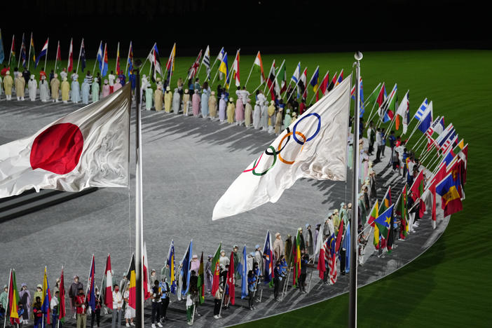 The Japan and Olympic flags fly as country flags are carried in during the closing ceremony in the Olympic Stadium at the Summer Olympics on Sunday in Tokyo.