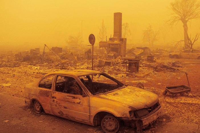 A burned residence rests in heavy smoke on Friday after being burned by the Dixie fire in Greenville, Calif. The fire is now the second-largest in recorded state history.