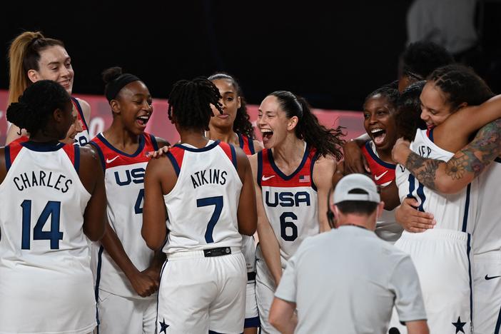 USA's players celebrate their victory at the end of the women's final basketball match between USA and Japan during the Tokyo 2020 Olympic Games. It was the squad's seventh consecutive Olympic gold.