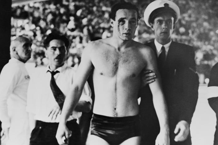 Hungary's Ervin Zador is led from the pool with blood pouring from a cut eye after a water polo match with the Soviet Union descended into chaos at the 1956 Melbourne Olympics. The Games played out in a volatile time — and thanks to a 17-year-old's letter, they ended on a note of unity.