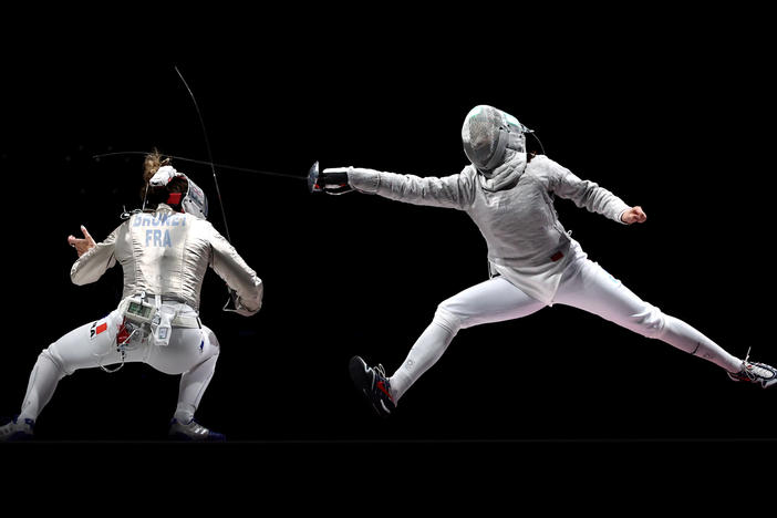 Over two weeks, critic Linda Holmes watched every Olympic discipline, from archery to wrestling. Above, Manon Brunet of Team France, left, competes against Olga Nikitina of Team ROC during the Women's Sabre Team Fencing Gold Medal Match on day eight of the Tokyo 2020 Olympic Games.