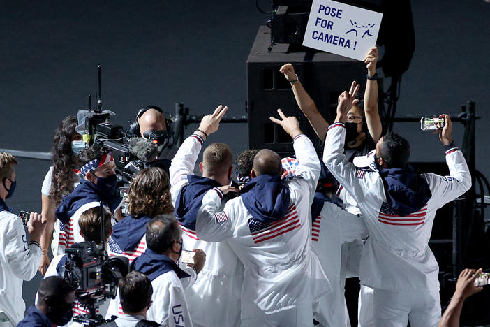 Members of the U.S. team pose for NBC cameras during the closing ceremony on Sunday.