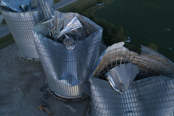Damaged grain bins are shown at the Heartland Co-Op grain elevator on Aug. 11, 2020, in Malcom, Iowa. Some people are still recovering a year after the 2020 derecho caused $11 billion in damage across the Midwest.