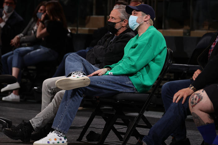 Jon Stewart and Pete Davidson sit court-side at a New York Knicks game on April 21, 2021 at Madison Square Garden in New York City, New York. They will hold a comedy special to benefit 9/11 charities there in September.