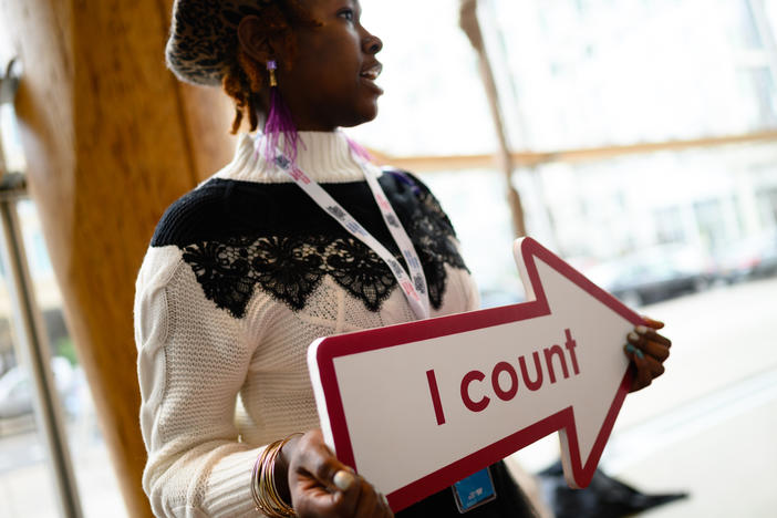 Whitney Turner, an employee of the U.S. Census Bureau, holds an "I count" sign at a 2020 census advertising campaign event in Washington, D.C., in January 2020.
