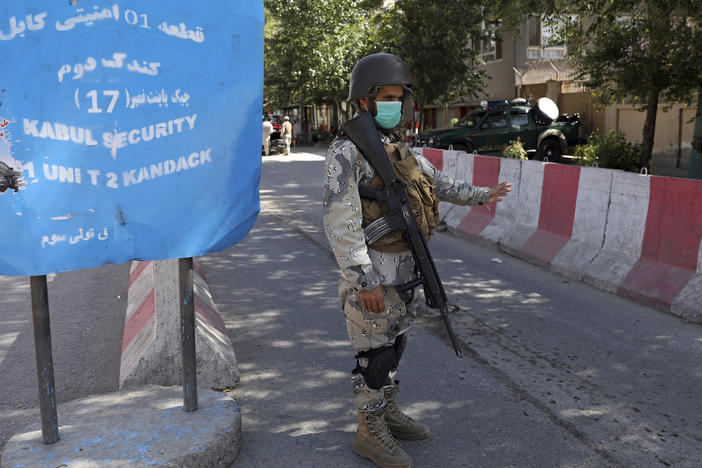 Afghan security personnel guard Kabul's Green Zone, which houses embassies, in May. An additional 3,000 U.S. troops are heading to Afghanistan to assist with evacuation efforts, according to the Pentagon.