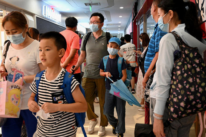 Students and parents walk after a private after-school session in Beijing's Haidan district, where competition is cutthroat for a spot in top schools.