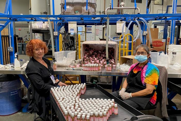 Alice Gomez and Maria Ramos work at Dr. Bronner's soap factory in Vista, Calif. The company is doing weekly coronavirus testing but still wants all its workers vaccinated.