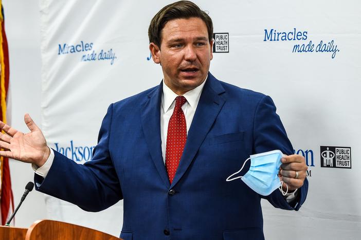 Florida Gov. Ron DeSantis speaks holding his facemask during a press conference to address the rise of coronavirus cases in the state, at Jackson Memorial Hospital in Miami, on July 13, 2020.